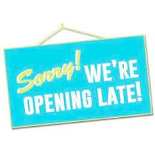 A blue sign withe the text "Sorry! We are opening late!"