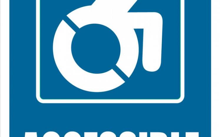 A blue sign with a white symbol of a person in a wheelchair moving forward.
